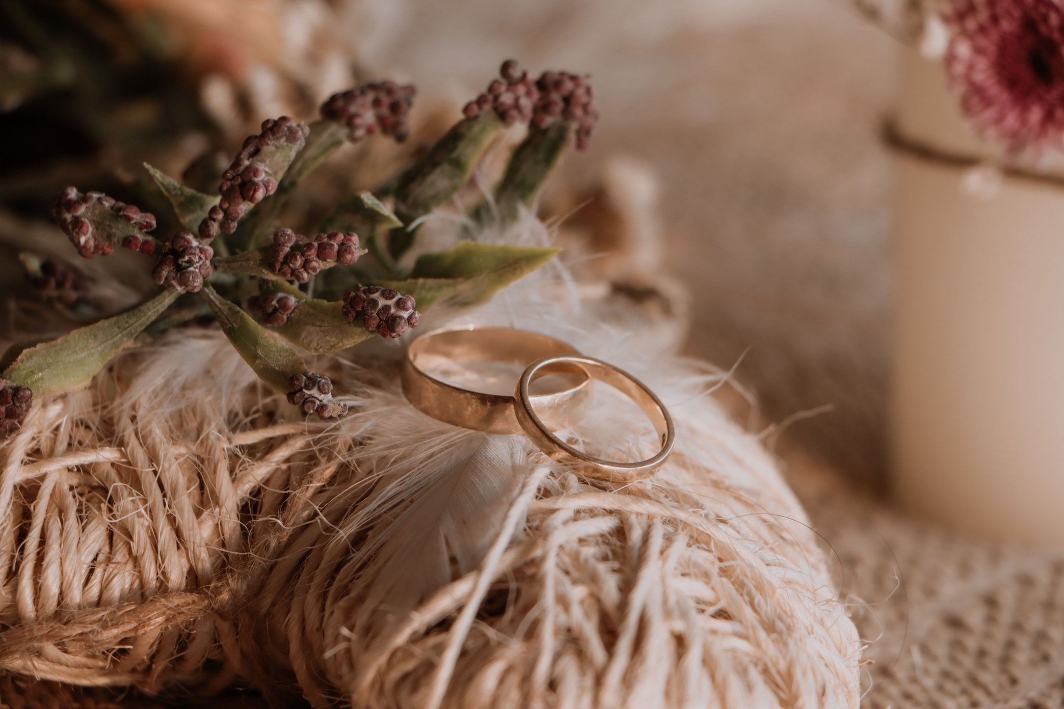 Two Gold Wedding Rings on Rustic Flower Bouquet